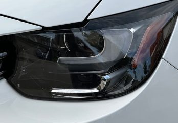 Closeup of a headlight on a white car